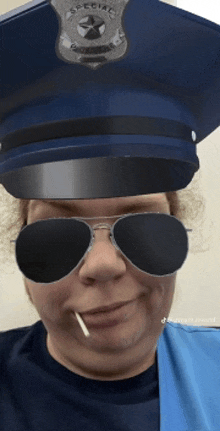 a woman wearing a police hat and sunglasses with a cigarette in her mouth