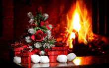 a small christmas tree is sitting in front of a fireplace