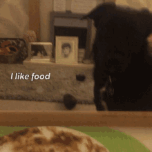 a black cat is standing in front of a table with the words i like food written on it