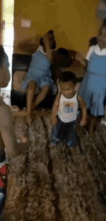 a group of people are sitting on a couch in a living room and a little boy is standing on a rug .