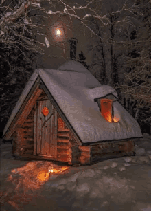 a log cabin in the snow with a sign on the door that says " open "