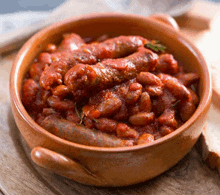 a bowl of sausage and beans in tomato sauce