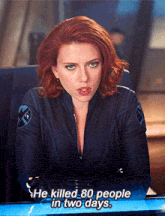 a woman with red hair is sitting at a desk with the words he killed 80 people in two days below her