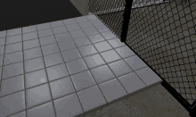 a white tile floor with a chain link fence behind it