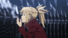 a blonde anime girl is smoking a cigarette in front of a fence