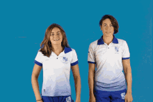 two women wearing blue and white shirts with the word bleu on the front