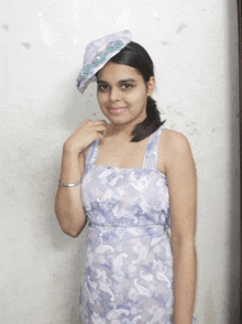 a girl wearing a floral dress and a hat