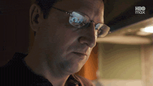 a close up of a man 's face with a hbo max logo in the corner