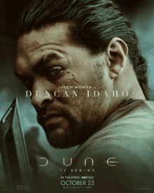 a movie poster for dune shows a man holding a knife