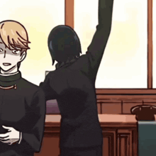 a man in a suit is standing next to a woman in a black suit who is raising her arm in the air .