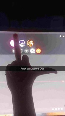 a hand giving the middle finger with the words fuck da discord ops