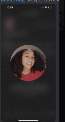 a phone screen shows a picture of a girl with curly hair and the time of 10:58