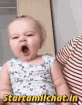 a baby is yawning and the website starttamilchat.in is displayed