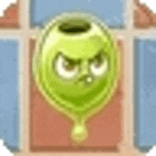 a green balloon with an angry face on it is hanging from a string .