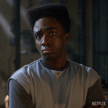 a man with a netflix logo on the bottom of his shirt