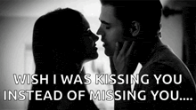 a black and white photo of a man and woman kissing with the caption `` wish i was kissing you instead of missing you . ''