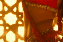a close up of a woman 's back with a red top