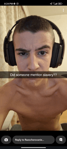 a shirtless man wearing headphones has a caption that says did someone mention slavery?