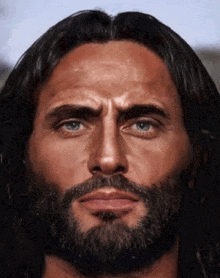 a man with long hair and a beard has a serious look on his face