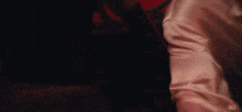 a woman in a white shirt is laying on a red bed