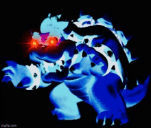 a blue and white monster with red eyes is standing in the dark .