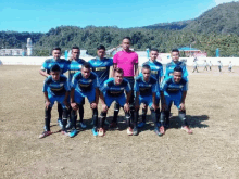 a group of soccer players are posing for a team photo on a field