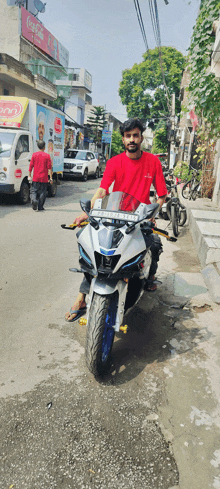 a man in a red shirt stands next to a white motorcycle