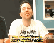 a man wearing a shirt that says " you should have a fancy fighting name " on it