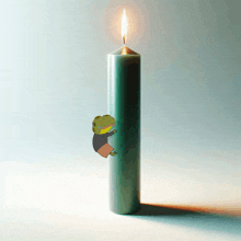 a green candle with a cartoon frog on it