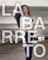 a woman is dancing in a parking garage with the words laba rre to written above her