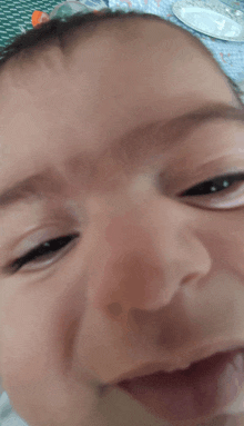 a close up of a baby 's face that is smiling