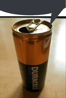 a can of duracell sits on a table next to a speech bubble