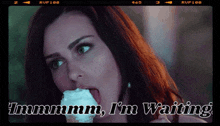 a woman is licking an ice cream cone and the caption says " immmm i 'm waiting "