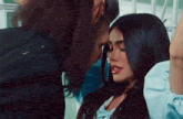 a man and a woman are looking at each other with their eyes closed