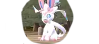 a white and pink pokemon with a bow on its head is sitting on a wooden surface .