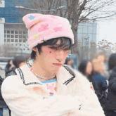a person wearing a pink hat and white jacket