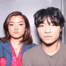 a man and a woman are posing for a picture in a booth .