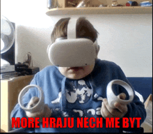 a boy wearing a virtual reality headset with the words more hraju nech me byt written below him