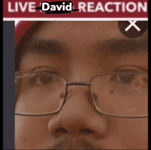 a close up of a man 's face with the words live david reaction written above him