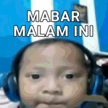 a blurry picture of a child with the words mabar malam ini on the bottom