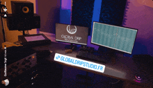 a computer desk with two monitors and a sign that says globaldripstudio.fr