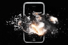 a broken cell phone is surrounded by pieces of glass and smoke .