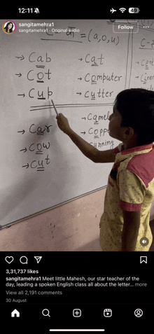 a little girl is writing on a whiteboard with the word cat written on it