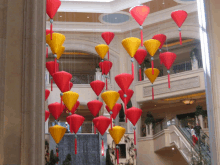 red and yellow lanterns are hanging from the ceiling