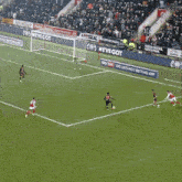 a soccer game is being played in front of a banner that says " we 've got the car for you "