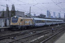 a yellow and blue train with a sign on the front that says ' santander '