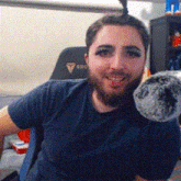 a man with a beard is holding a stuffed animal .