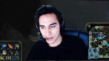 a man wearing headphones is playing a video game on a computer screen