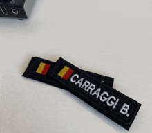 two patches with the name carraggi b. on them