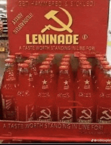 a display of red bottles of leninade with a hammer and sickle on the label .